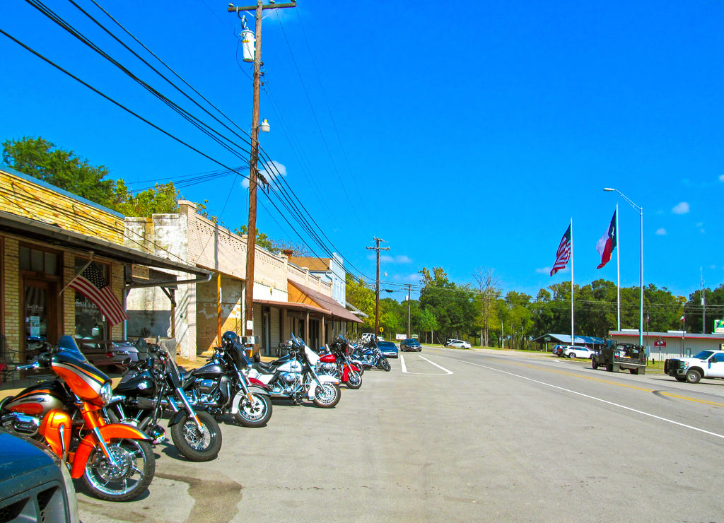 Parking motorcycles in a row along the street. Motorbikes of bikers parked at the usual meeting place near Canton in Texas on a sunny day during a weekend trip