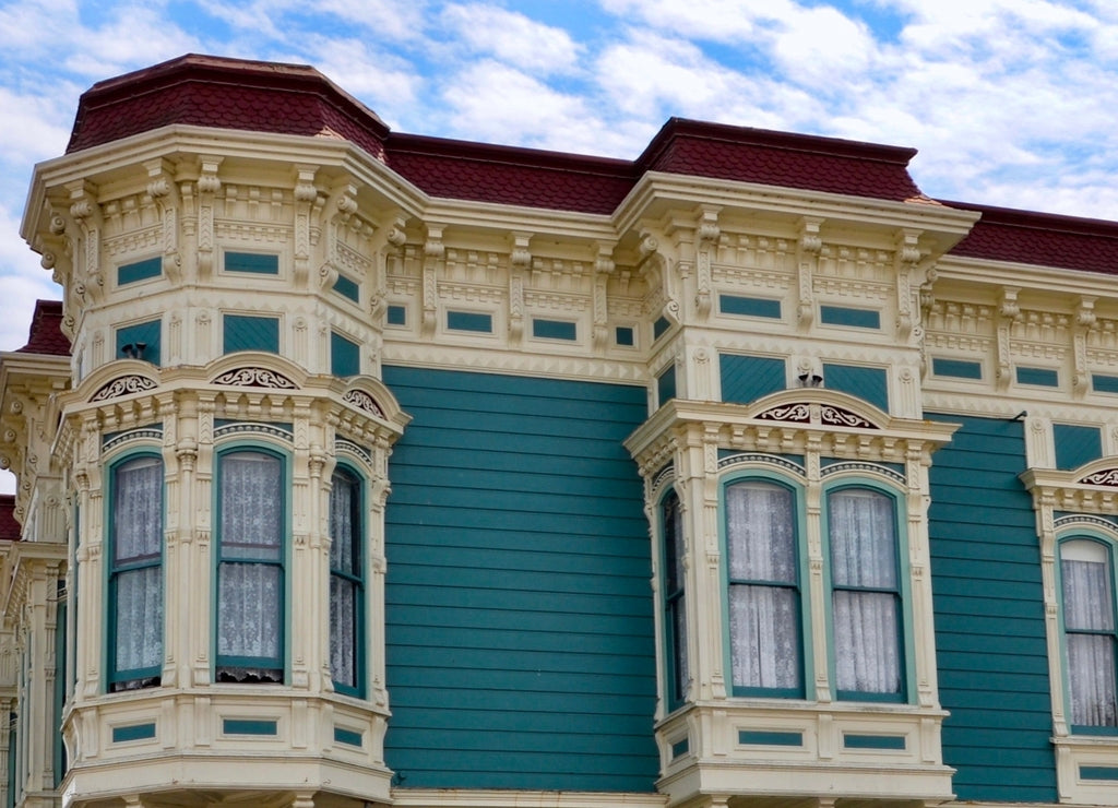 Closeup of traditional house in the city of Ferndale in Humboldt County, California, USA, famous for its Victorian architecture, a sunny day with blue sky and clouds in summer