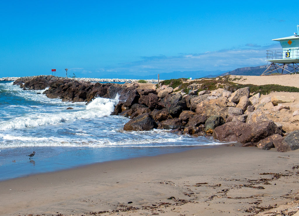 Lifeguard tower and rock jetty seawall in Ventura California United States