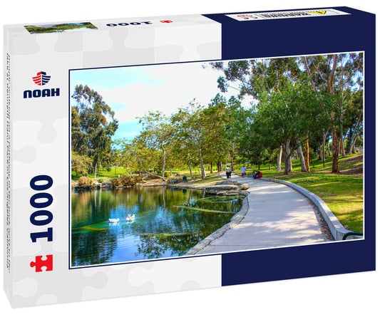 people walking on a pathway in the park next to the lake at Kenneth Hahn Park in Los Angeles California