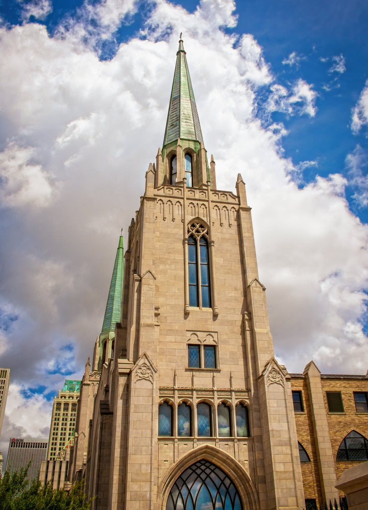 Cityscape of Tulsa Oklahoma USA with gothic chruch with copper spires in foreground