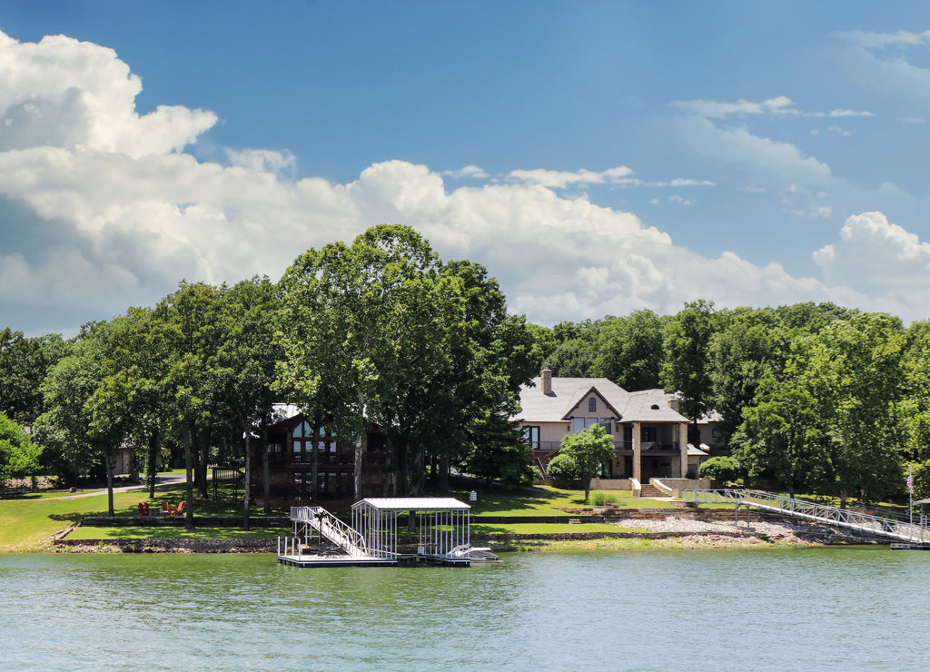 Luxury houses built beside lake with docks and little beaches among the trees, Oklahoma