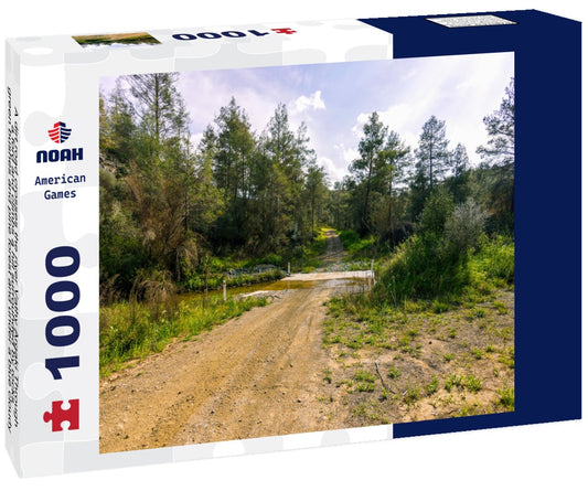 Noah Jigsaw Puzzle A dirt road crosses the river Vathy Argaki Through a ford and climbs a hill surrounded by rocks, green bushes and pine forest and under a blue cloudy sky (Kornos, Larnaca District, Cyprus) 1000 pieces
