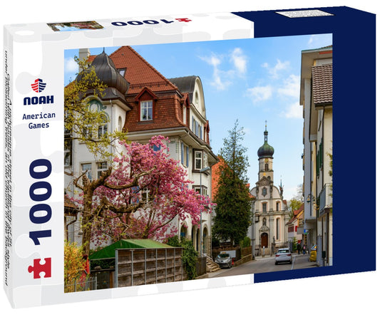 Noah Jigsaw Puzzle A picturesque street in the city of St. Gallen with houses in the traditional Swiss style under blossoming trees, an old church in the background 1000 pieces