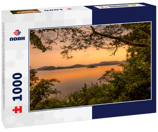 Lake Mutanda at sunset with view on the volcanoes mount Muhavuru and mount Gahinga in East Africa, along the border of Rwanda and Uganda