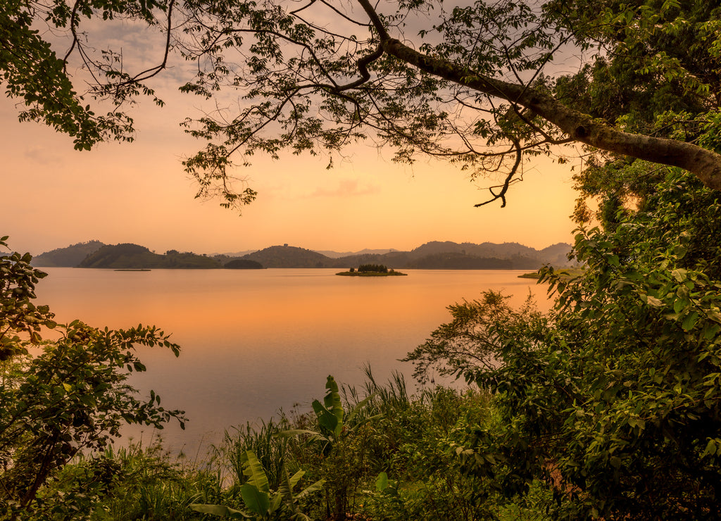 Lake Mutanda at sunset with view on the volcanoes mount Muhavuru and mount Gahinga in East Africa, along the border of Rwanda and Uganda