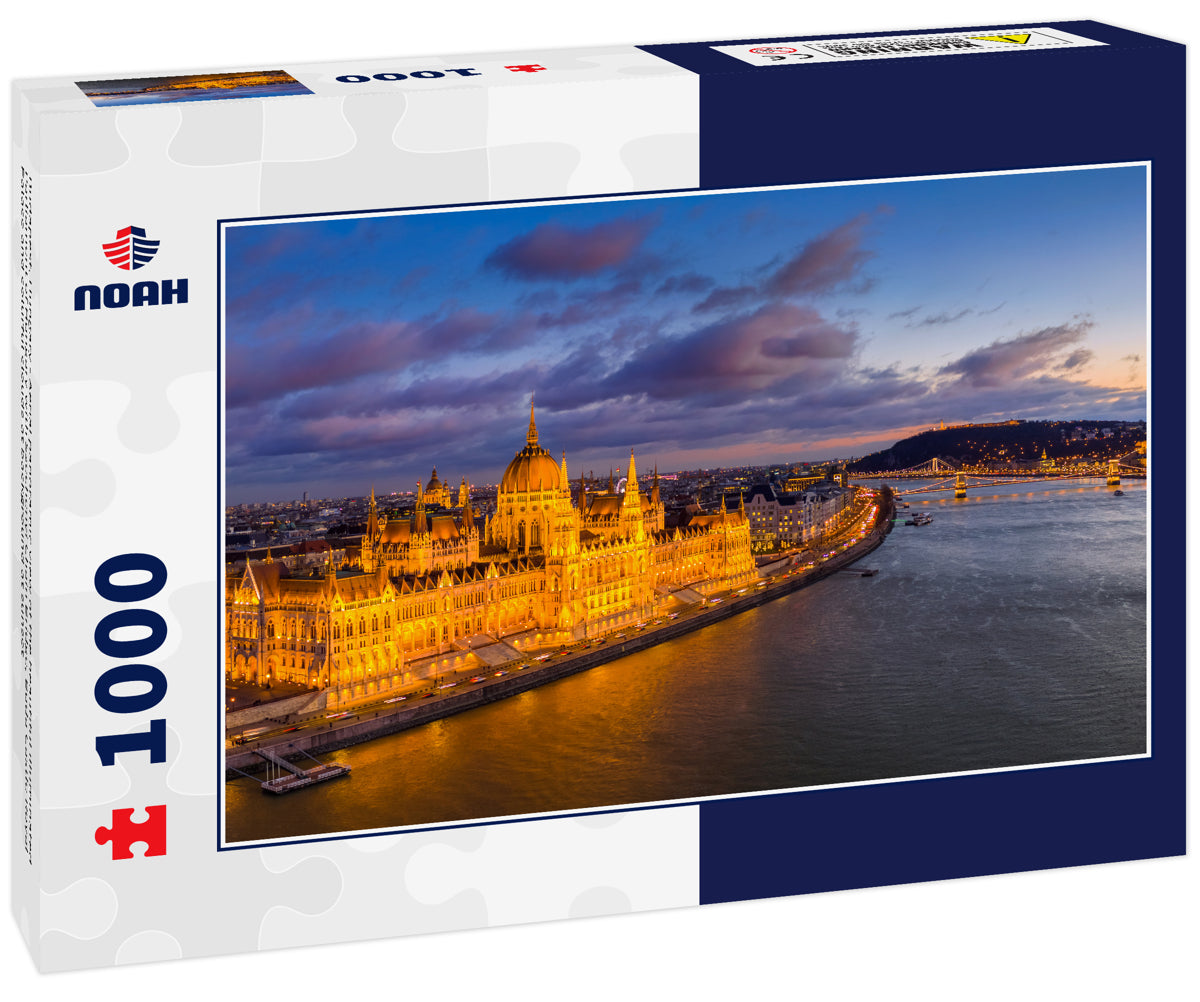 Budapest, Hungary - Aerial panoramic view of the beautiful illuminated Parliament of Hungary with Szechenyi Chain Bridge, Buda Castle Royal Palace and colurful clouds at background at sunset