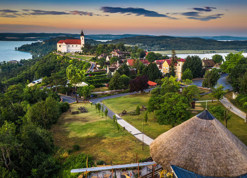 Tihany, Hungary - Panoramic view of the beautiful village of Tihany on the northern shore of Lake Balaton with the Benedictine Tihany Abbey (Tihanyi apatsag), Inner Lake and a colorful sky at sunrise