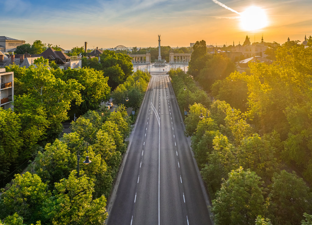 Budapest, Hungary - Aerial drone view of Andrassy street at sunrise with Heroes' Square (Hosok tere) at background at summer time