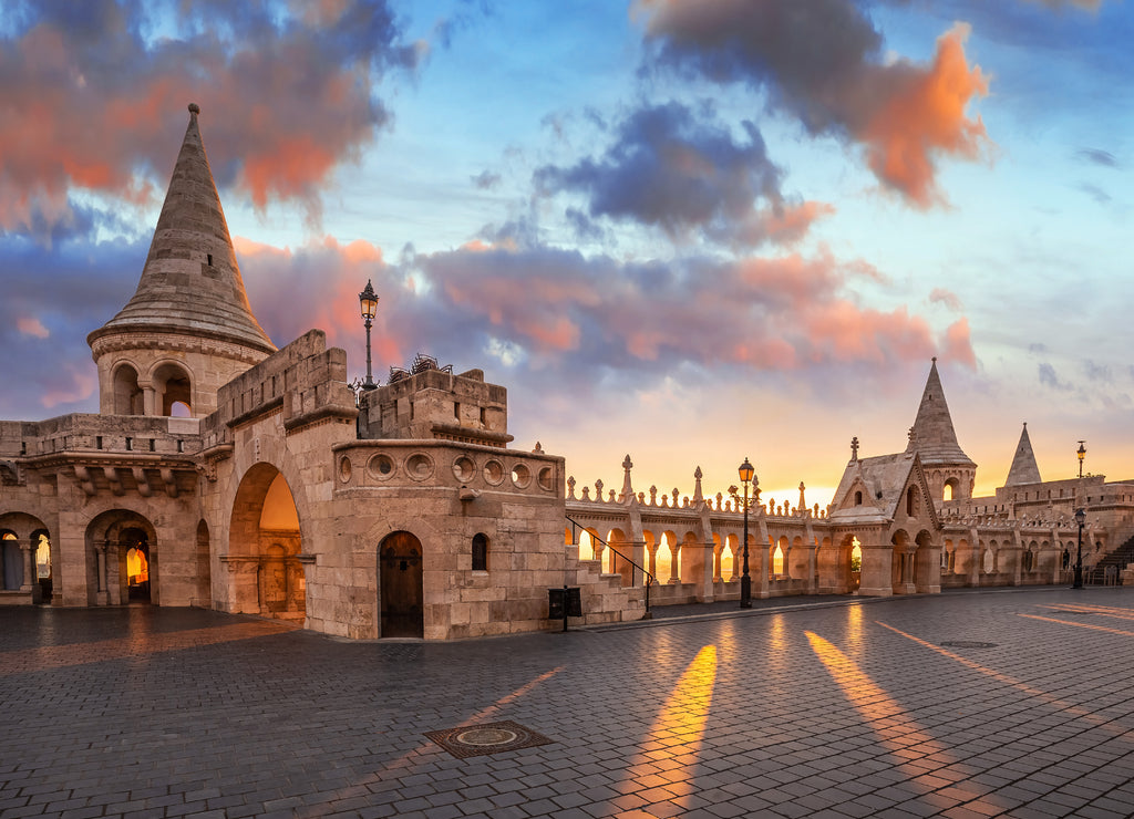 Budapest, Hungary - Beautiful autumn sunrise at Castle district and Fisherman's Bastion with warm sunlight and orange and blue sky and clouds