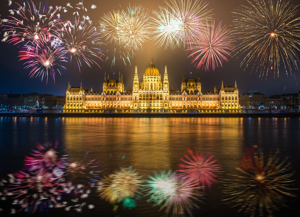 Hungarian parliament with fireworks reflected in Danube river. Budapest