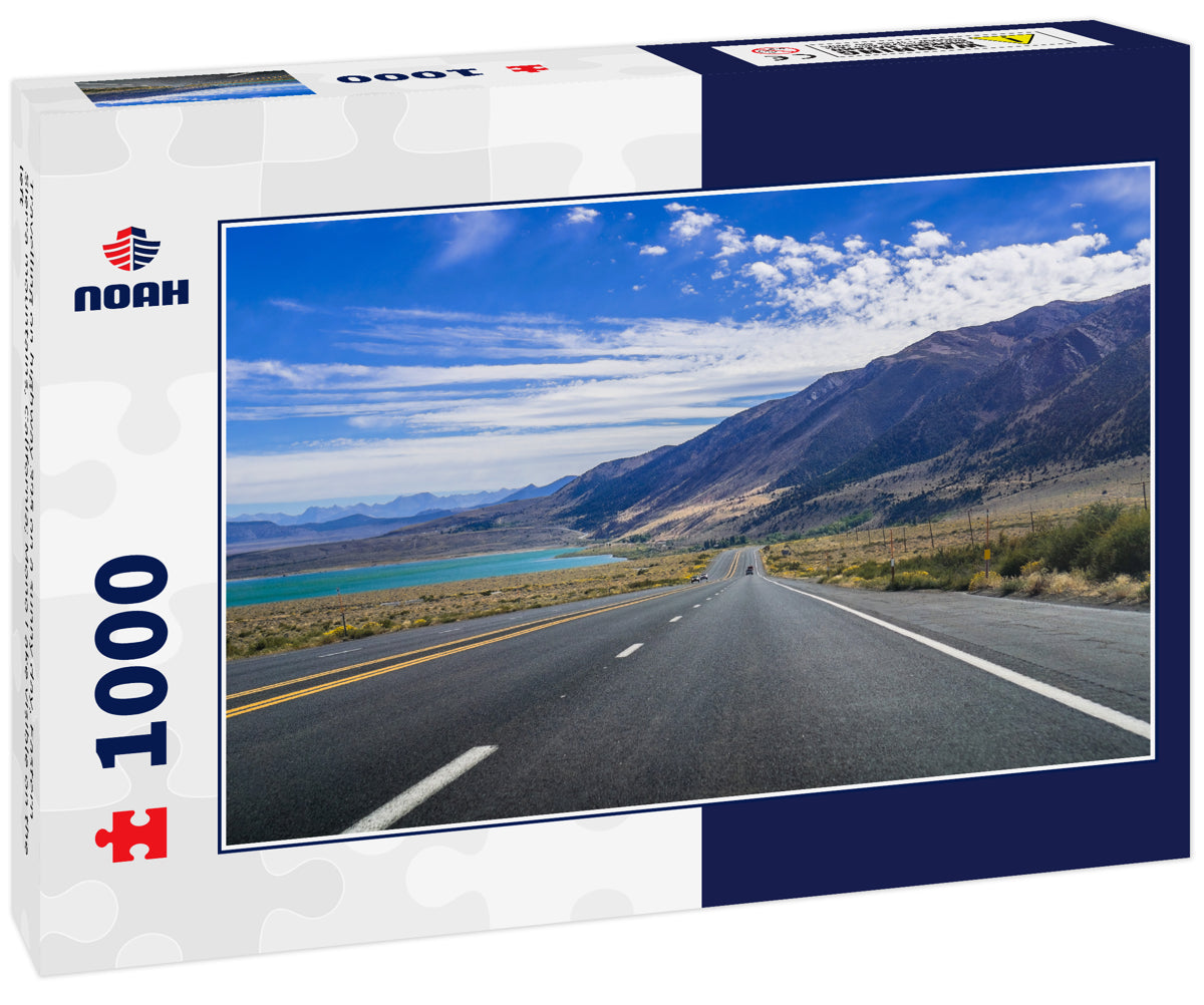 Travelling on highway 395 on a sunny day, Eastern Sierra mountains, California; Mono Lake visible on the left