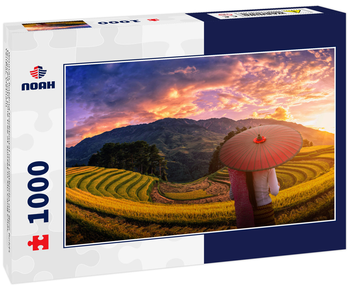 Woman holding traditional red umbrella on Rice fields terraced with pine tree at sunset in Mu Cang Chai, YenBai, Vietnam
