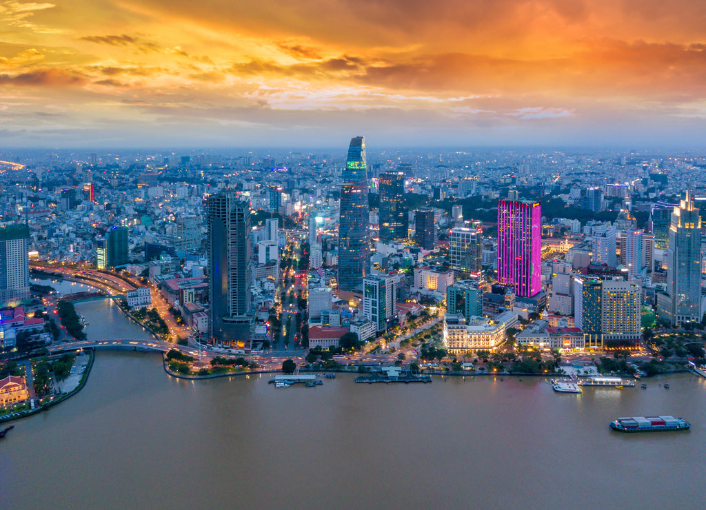 Aerial view of Ho Chi Minh City skyline and skyscrapers in center of heart business at Ho Chi Minh City downtown. Panorama of cityscape on Saigon river in Ho Chi Minh City at Vietnam at sunset scene