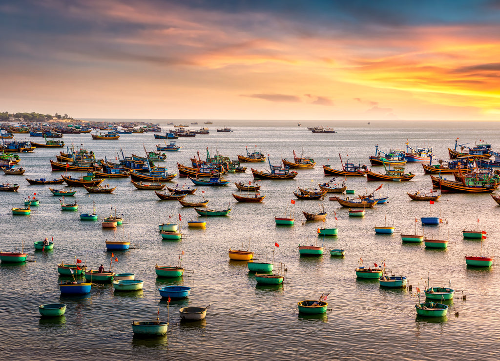 Traditional Vietnamese boat in the basket shaped on fishing port at Fishing village in sunset sky , Binh Thuan, Vietnam. Landscape. Popular landmark, famous destination of Vietnam