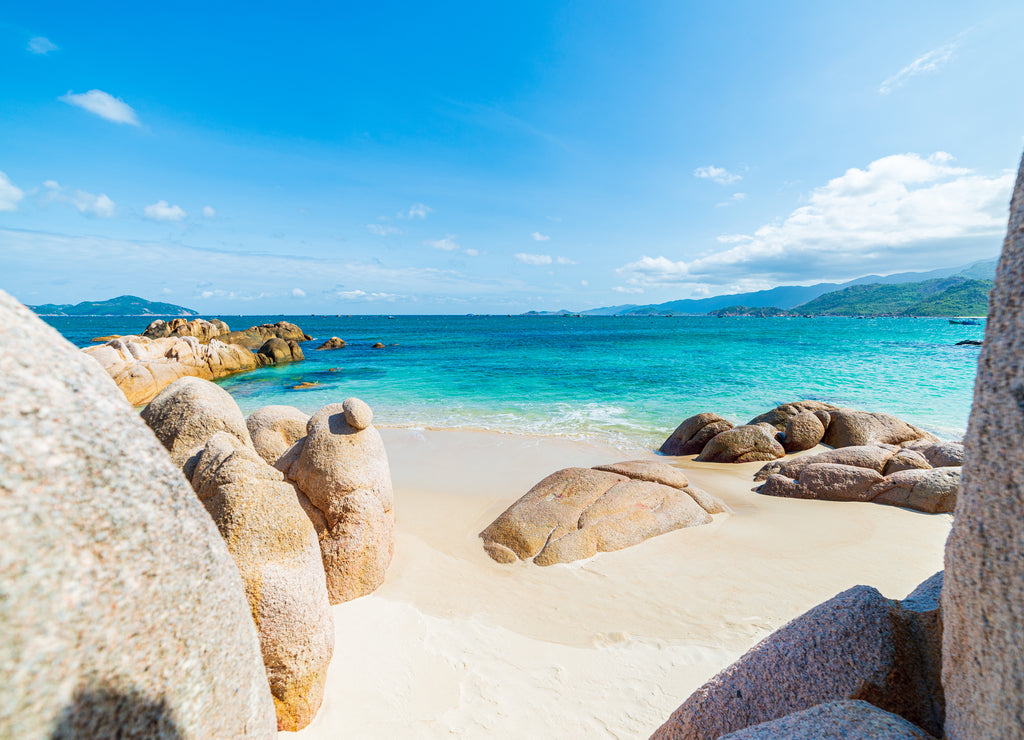 Gorgeous tropical beach turquoise transparent water unique rock boulders, Cam Ranh Nha Trang Vietnam