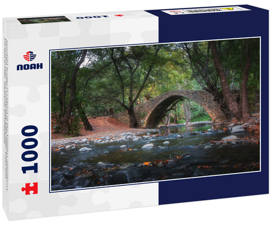 Venetian bridge in Cyprus in the Troodos mountains. Beautiful autumn landscape with river, trees and ancient bridge. Medieval architecture