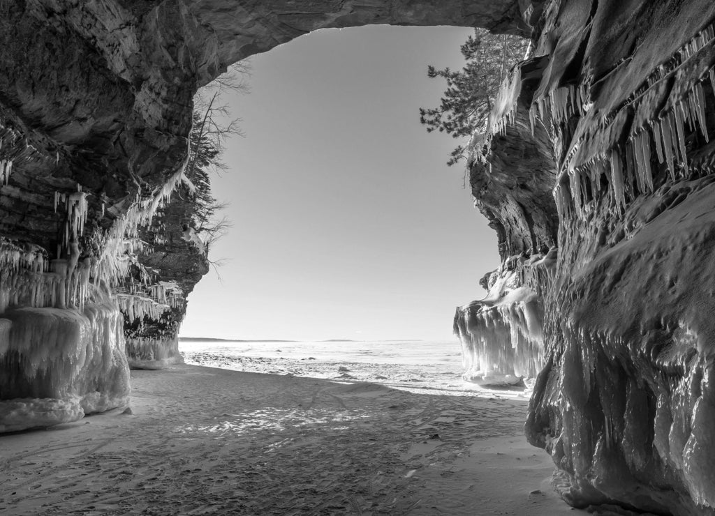 Icicle and snow-laden shoreline sandstone formations on Wisconsin's Apostle Islands National Lakeshore near Meyer's beach; Lake Superior in black white