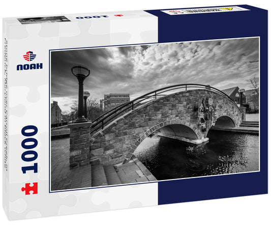 Stone bridge over Carroll Creek, in Frederick, Maryland in black white