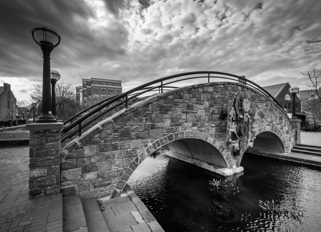 Stone bridge over Carroll Creek, in Frederick, Maryland in black white
