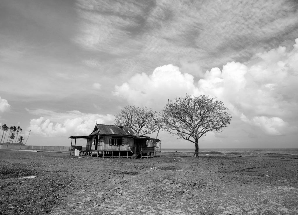 Old abandoned house under blue sky near the beach, North Dakota in black white