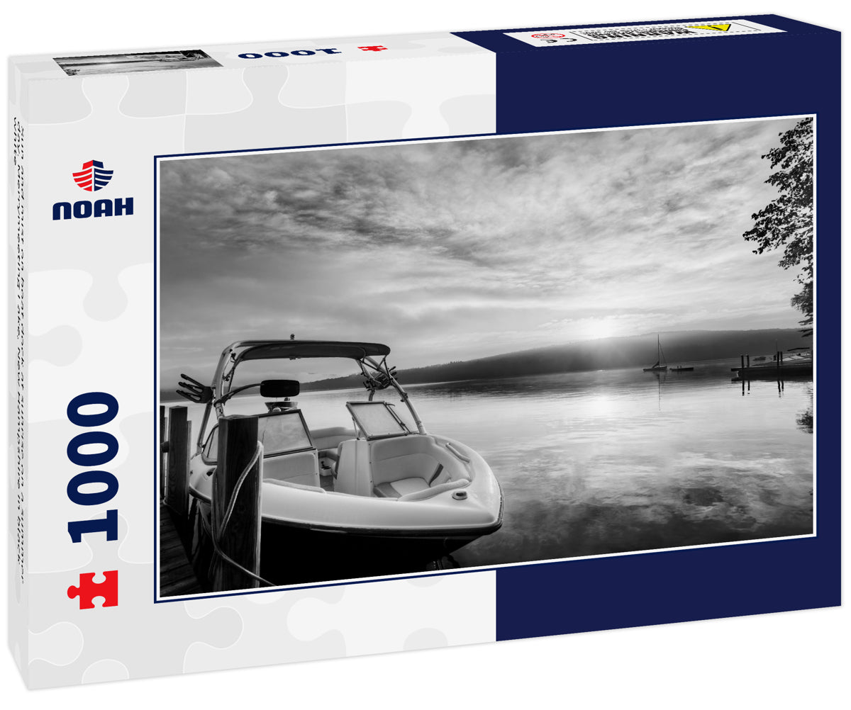 Sun and mist on boat dock at sunrise on a summer day. Merrymeeting Lake, New Hampshire in black white