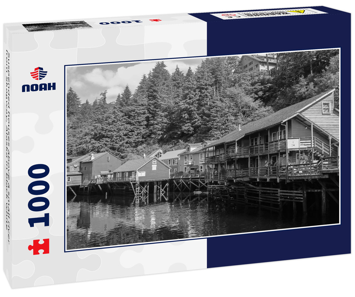 Suspended houses above a small river from Skagway, Alaska in black white