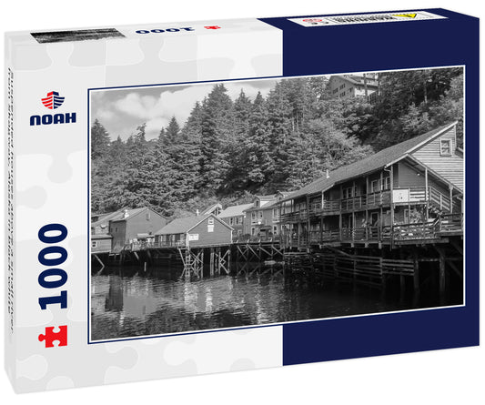 Suspended houses above a small river from Skagway, Alaska in black white