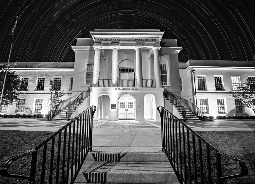 November 2016 town of Walterboro South Carolina USA - Town of walterboro courthouse at night with star trails in the background in black white
