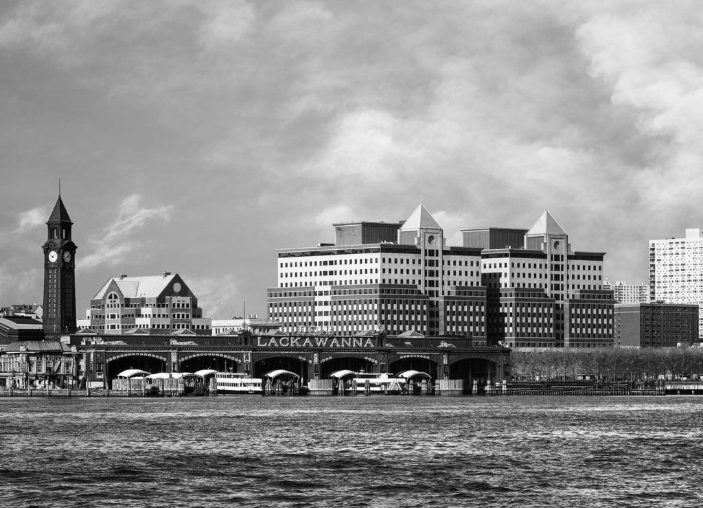 Hoboken, New Jersey waterfront and skyline viewed from the Hudson River. The historic Lackawanna train terminal, built 1907, is seen in the foreground in black white