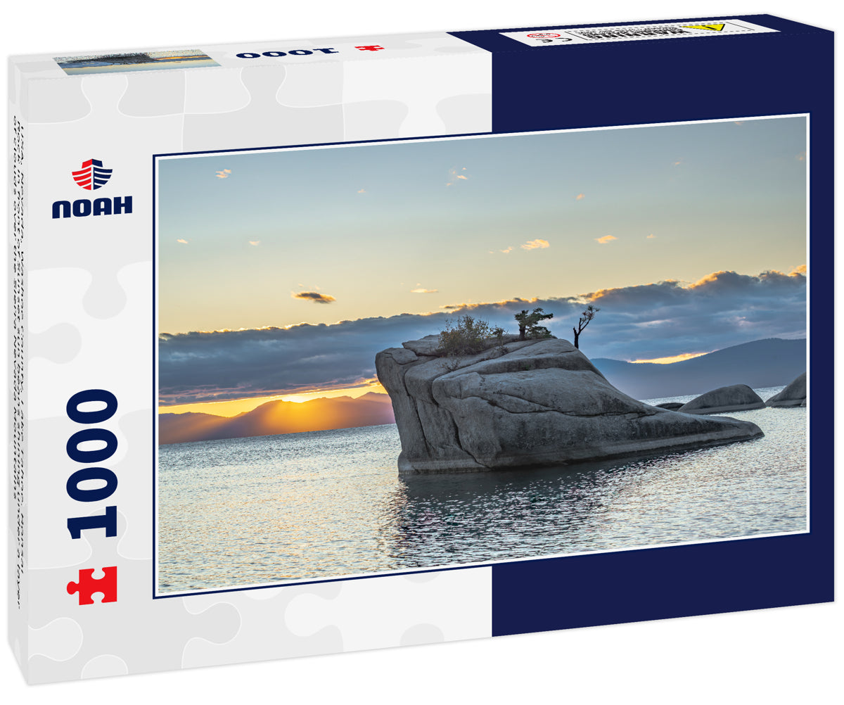 USA, Nevada, Washoe County, Lake Tahoe. Bonsai Rock in front of Sunset sun beans shining under a layer of clouds over the Sierra Nevada Mountains