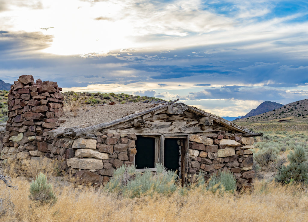 USA, Nevada, Nye County, Grant Range. Sunset over a stone cabin along the Pony Express Route and Overland Stage Line. Red Mountain is visible in the background right