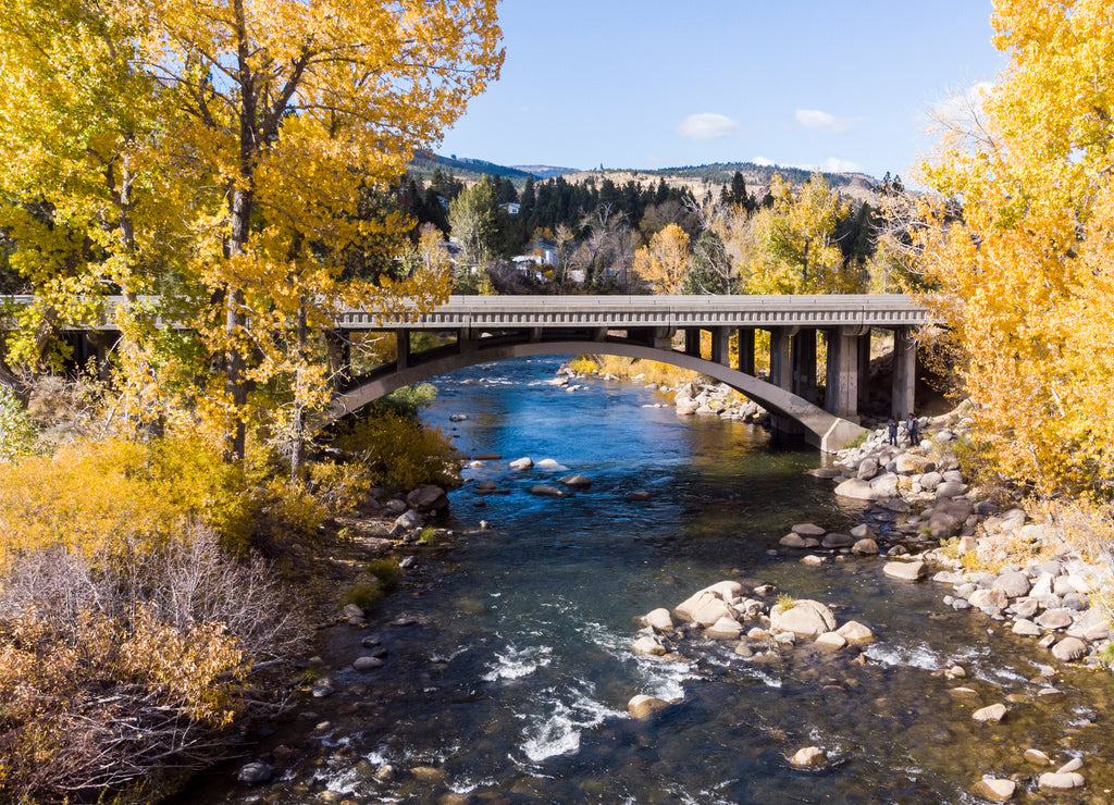 Drone point of view over the Truckee river as it passes under a bridge near Crystal Peak park in Verdi, Nevada 