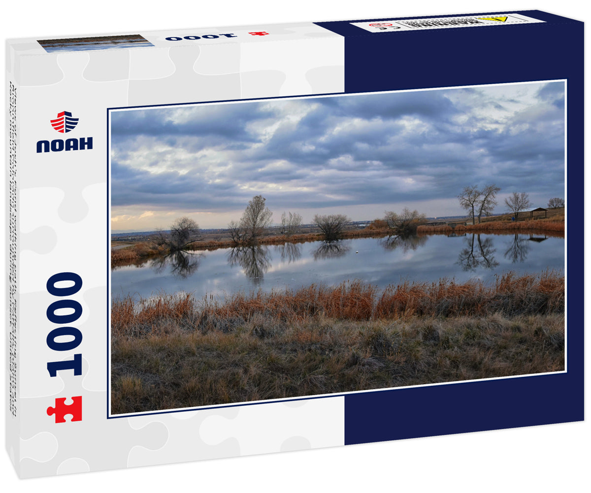 Views of Josh’s Pond walking path, Reflecting Sunset in Broomfield Colorado surrounded by Cattails, plains and Rocky mountain landscape during sunset. United States