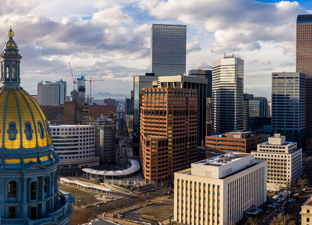 Colorado State Capitol Building & the City of Denver Colorado at Sunset. Rocky Mountains on the Horizon