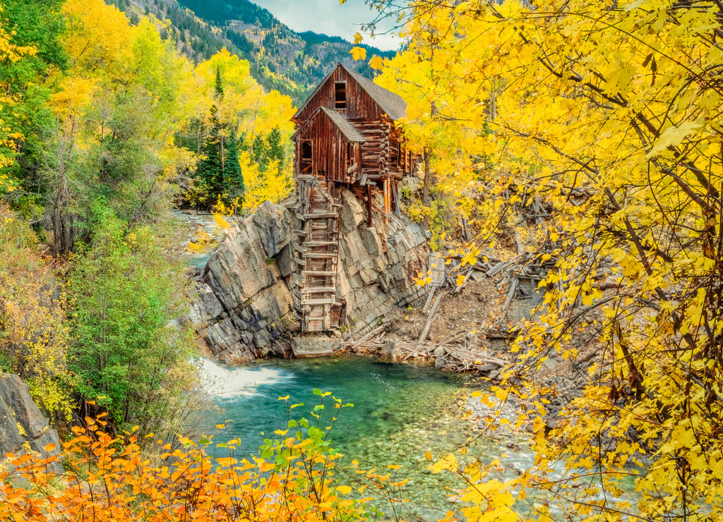 Crystal Mill, an abandoned powerhouse is surrounded by fall aspens of the Gunnison National Forest in Colorado