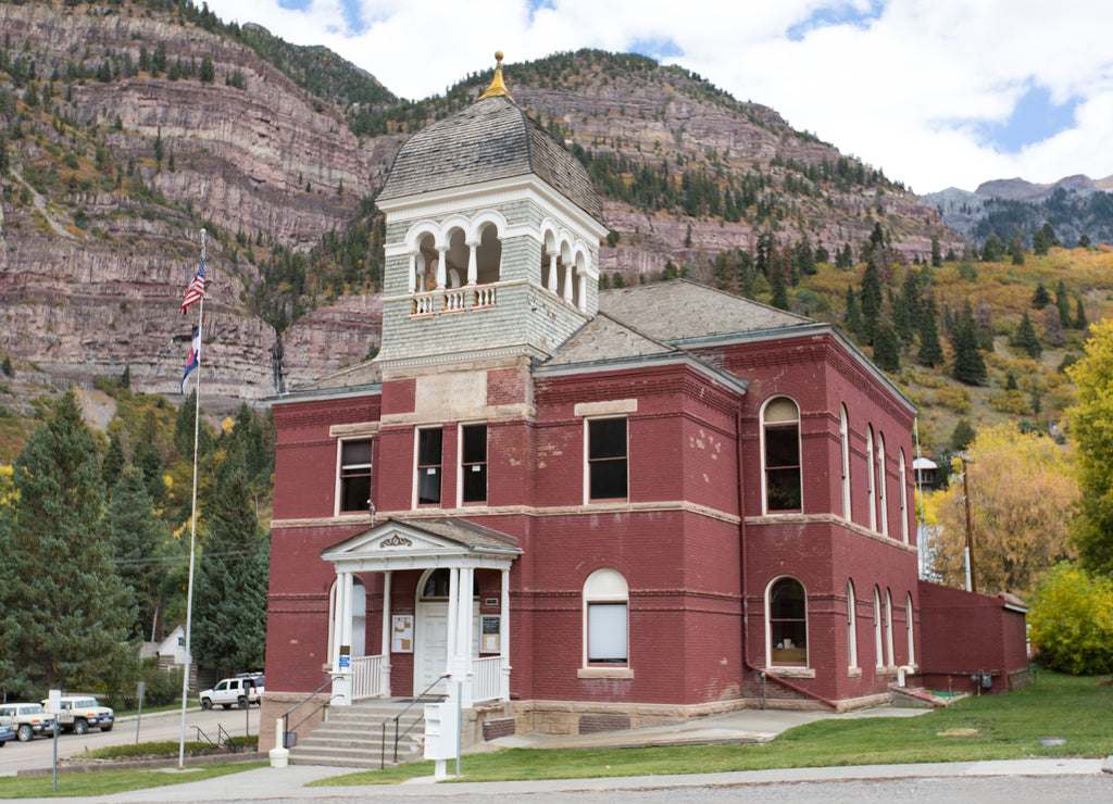 Ouray County Courthouse with peaks of the locally known Ampitheater formation in the background, Colorado
