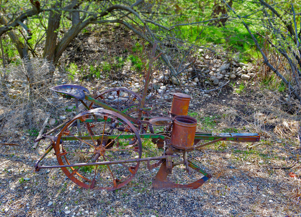 Rustic and vintage John Deere plow located on a local farm in Boise Idaho