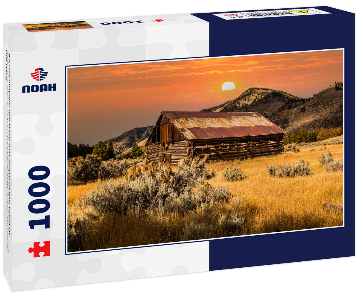 An old vintage log barn just north of the town of Salmon, Idaho. Aspen trees and sage brush surround the barn