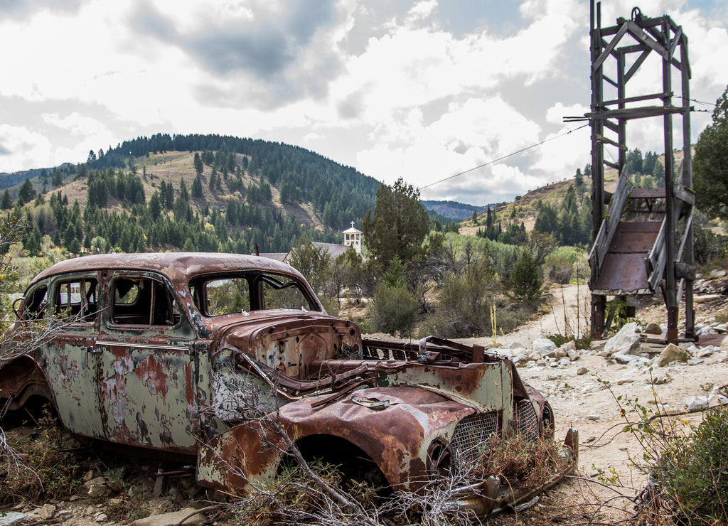 Old rusty vehicle in Silver City Idaho with suicide doors and handles