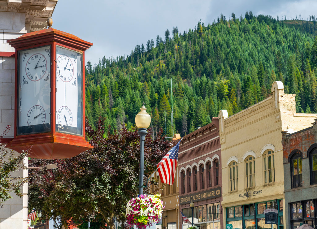 An antique clock showing time and temperature on the corner of a vintage building in the historic mining town of Wallace, Idaho, USA