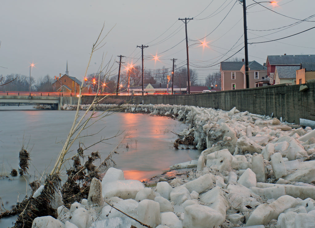 a long exsposer of an Ice floe pushed up onto the river bank and against the river containment wall on the Eel river in logansport Indiana