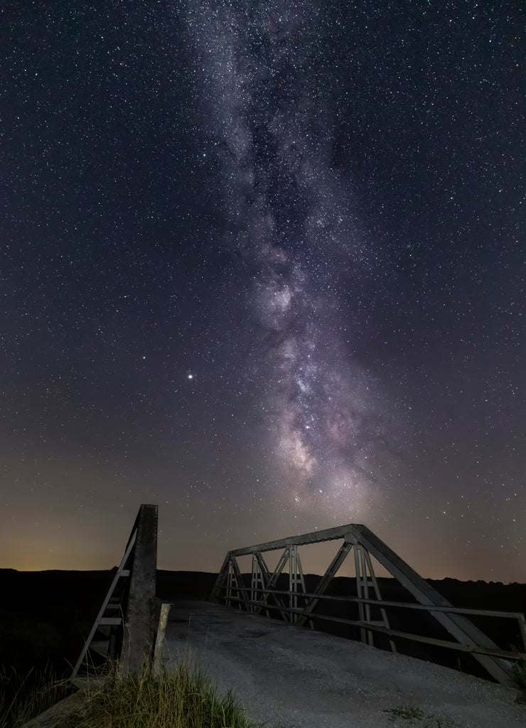 The Milky Way Galaxy stretches across a night sky full of stars at Measle Road Bridge in rural Morgan County, Indiana