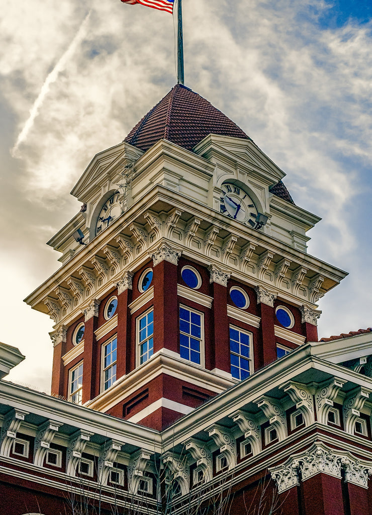 Old Indiana courthouse clock tower with American flag on pole