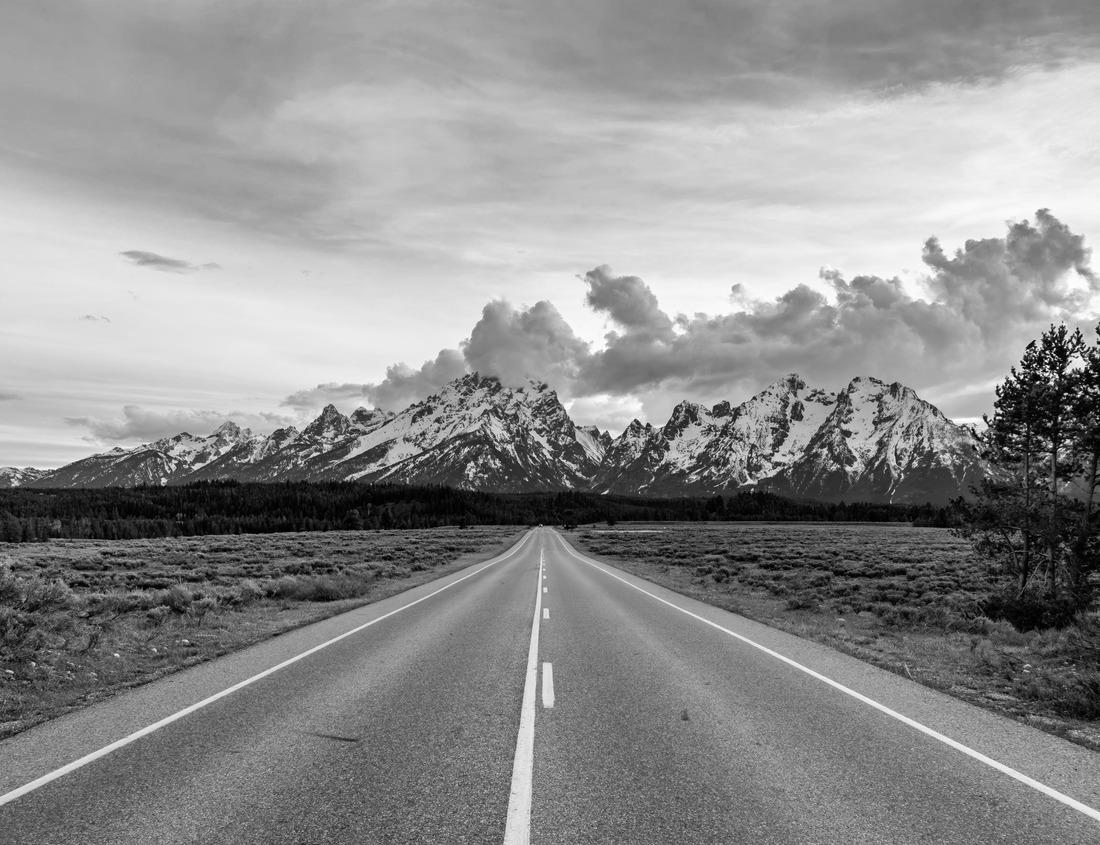 Noah Jigsaw Puzzle A dirt road crosses the river Vathy Argaki Through a ford and climbs a hill surrounded by rocks, green bushes and pine forest and under a blue cloudy sky (Kornos, Larnaca District, Cyprus) in black white 1000 pieces
