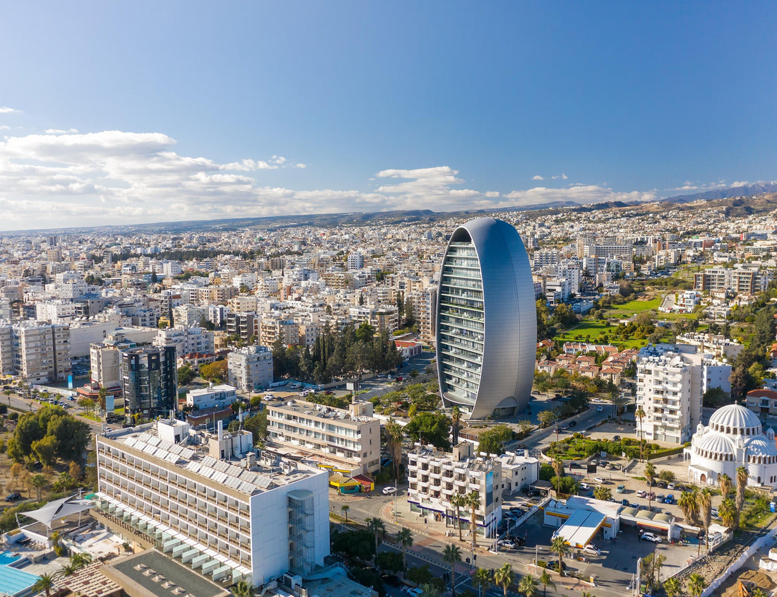 Noah Jigsaw Puzzle Drone shot of a bustling Limassol cityscape with a distinctive elliptical glass tower on a clear day. Cyprus 1000 pieces
