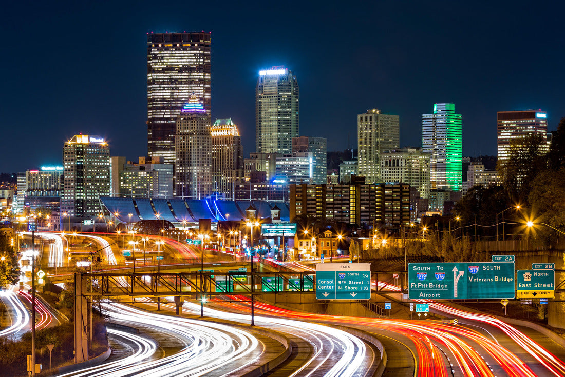Noah Jigsaw Puzzle Pittsburgh skyline by night. The rush hour traffic leaves light trails on I-279 parkway 2000 pieces