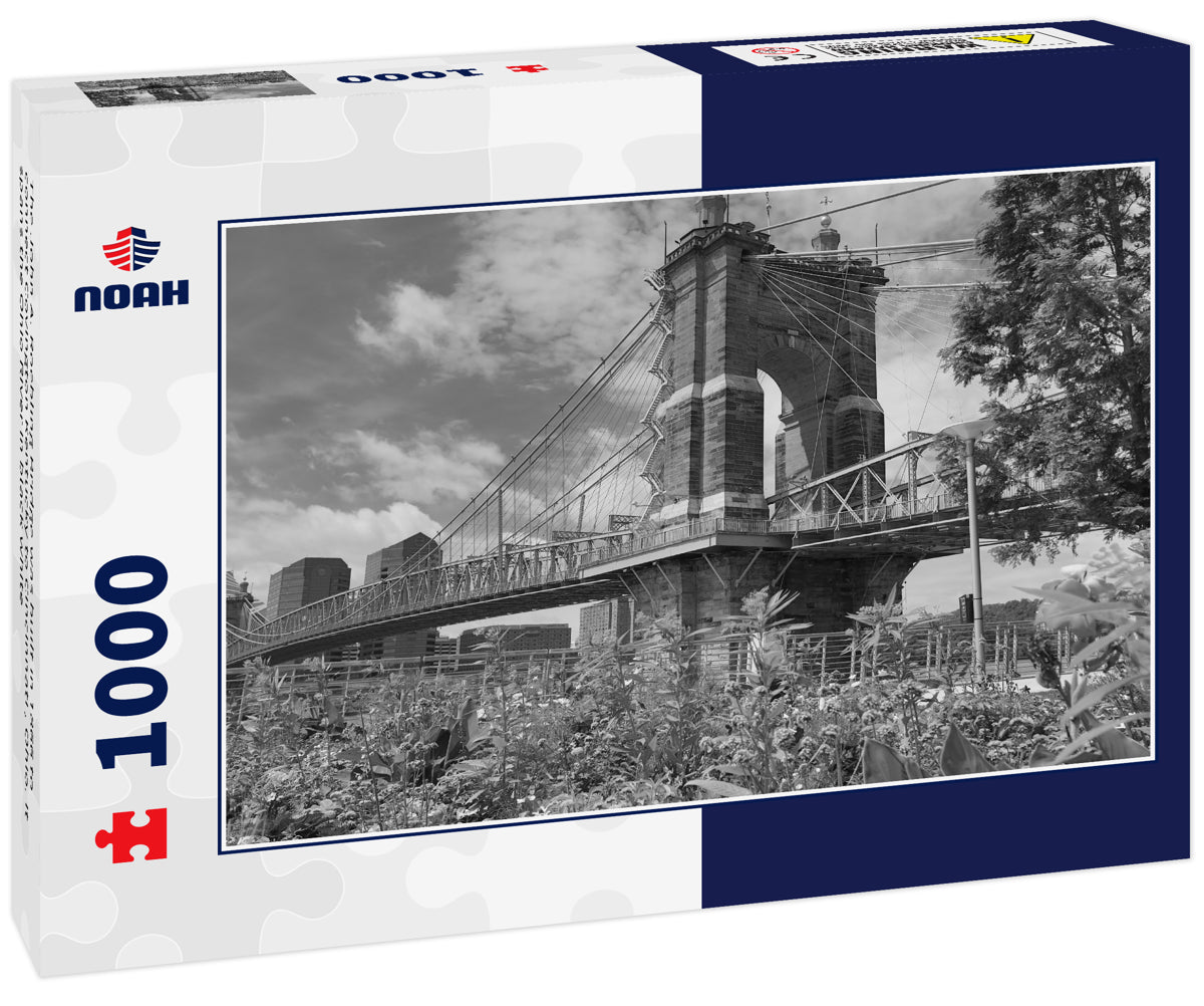 The John A. Roebling Bridge was built in 1866 to connect Covington Kentucky to Cincinnati , Ohio. It spans the Ohio River in black white