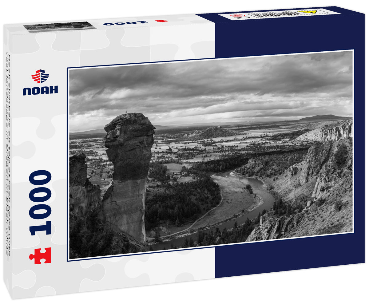 Rock climbers on top of rock spire with vast landscape in Oregon in black white