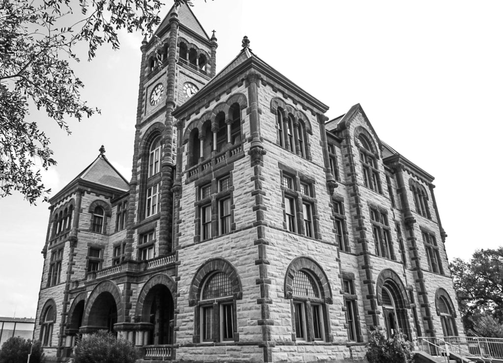 The Historical Landmark of the De Witt County Courthouse in Cuero, Texas along the Independence Trail in black white